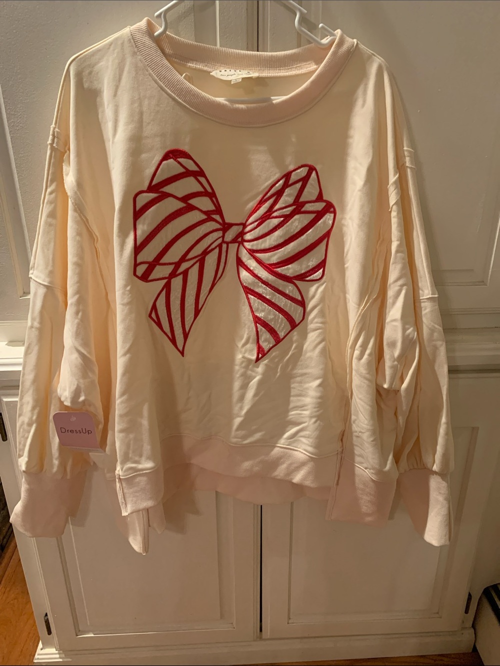 Cream Women's Sweatshirt with Red Bow Graphic